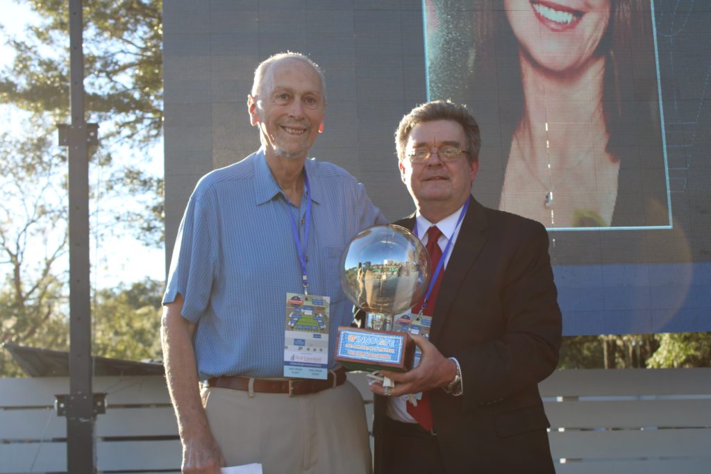 Dr. Hauswirth receiving Innovator of the Year award from Dr. Norton