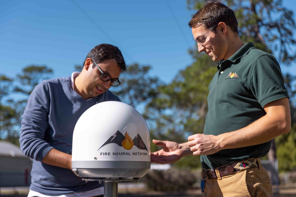 Two engineers work on a fire detection system