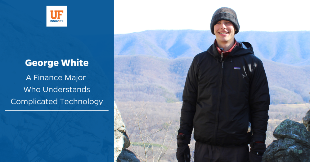 Intern George White is pictured at the top of a mountain he's climbed