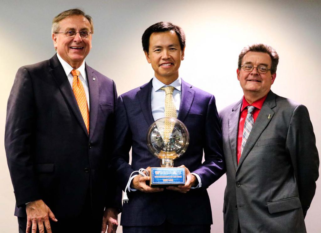 Inventor Ben Lok stands with University of Florida President Kent Fuchs and Vice President for Research Dr. David Norton