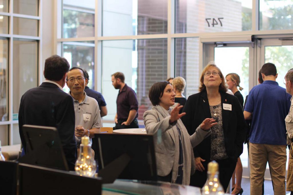 Technology Licensing Officer and Dr. Christine Schmidt talk at Standing InnOvation, an event during which Dr. Schmidt's and Dr. Thomas Angelini's spinal cord model was selected as an "Invention of the Year."