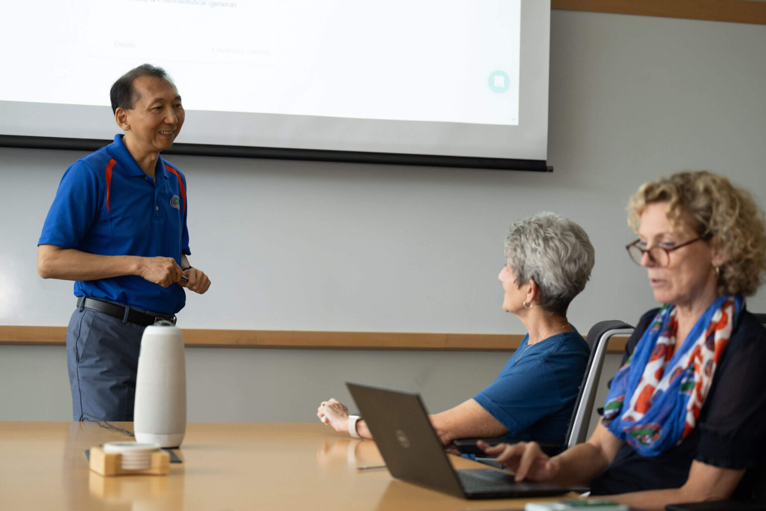 UF Innovate staff having a discussion in a conference room.