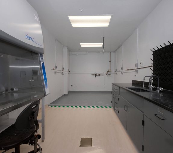 A lab featuring a machine and a sink.