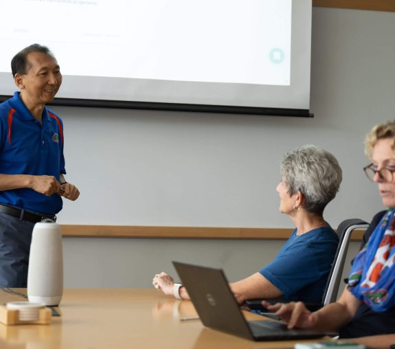 UF Innovate staff having a discussion in a conference room.