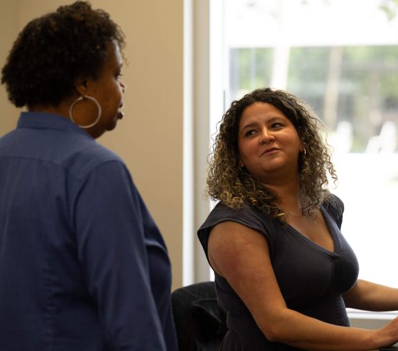UF staff having a conversation in an office.