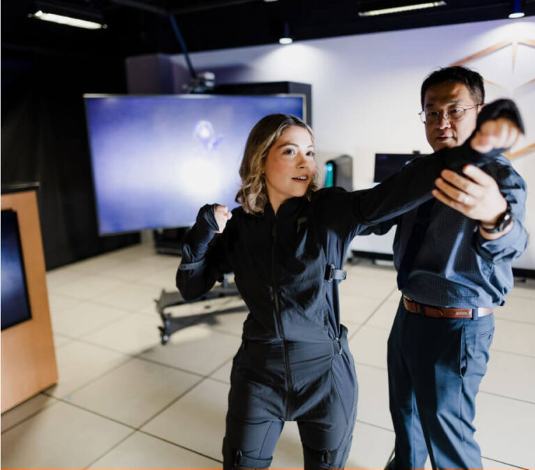 People testing a new technology using a motion capture suit.